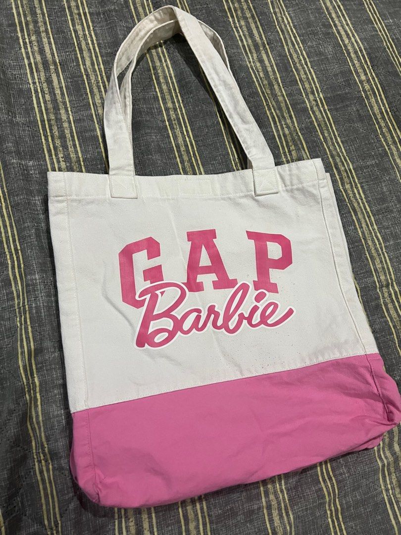 GAP x Barbie Pink Large Tote Bag (Category: Tote Bags) located in Cavite. Submitted by charlotte_alexandra16 (Listing ID 1386984024, Image 1). Description: No issues, just needs a good wash. Can fit up to 15inch laptop, measured length and width when flat on ground (see uploaded photos) .