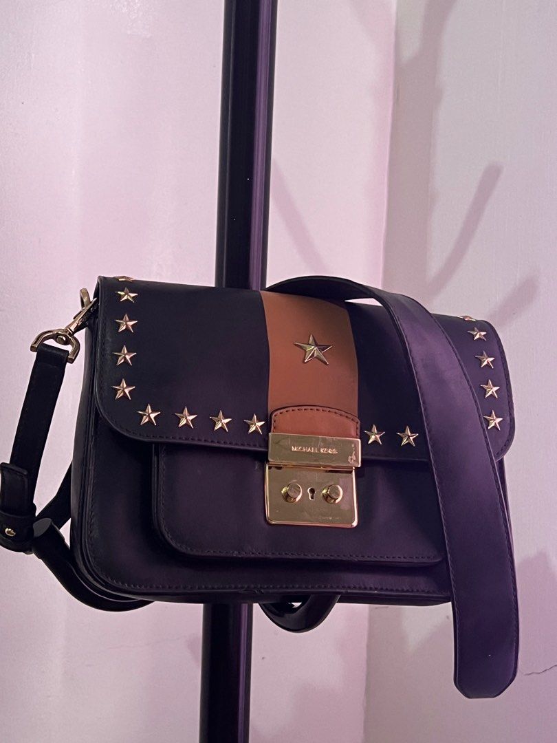 Michael Kors Sloan Editor Studded Leather Shoulder Bag (Category: Luxury Bags & Wallets) located in Santiago. Submitted by mariesimon (Listing ID 1387197996, Image 2). Description: 9”L x 6-1/2”H x 2-1/2”W (width is measured across the bottom of handbag); 1.37 lbs. approx. weight 15-1/2”L to 18”L removable strap Push-lock closure Gold-tone exterior hardware, 1 open compartment & 1 back snap pocket 1 interior zip pocket & 3 front pockets Leather.