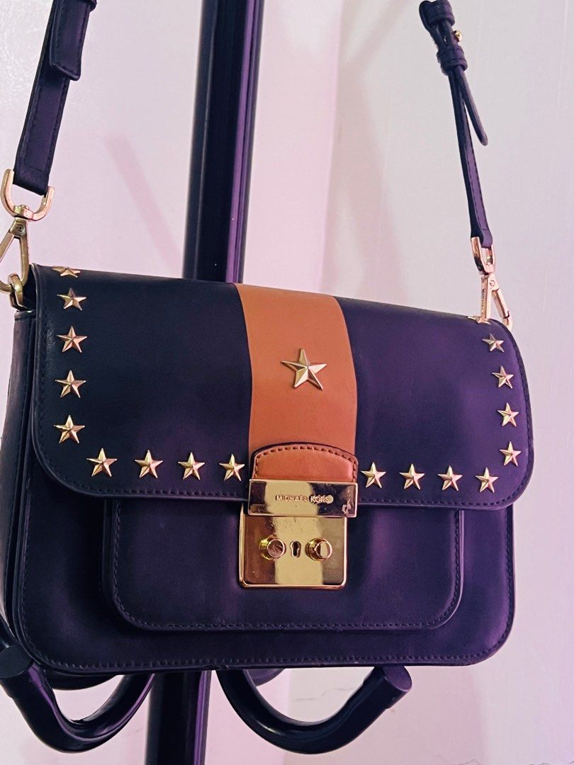Michael Kors Sloan Editor Studded Leather Shoulder Bag (Category: Luxury Bags & Wallets) located in Santiago. Submitted by mariesimon (Listing ID 1387197996, Image 1). Description: 9”L x 6-1/2”H x 2-1/2”W (width is measured across the bottom of handbag); 1.37 lbs. approx. weight 15-1/2”L to 18”L removable strap Push-lock closure Gold-tone exterior hardware, 1 open compartment & 1 back snap pocket 1 interior zip pocket & 3 front pockets Leather.