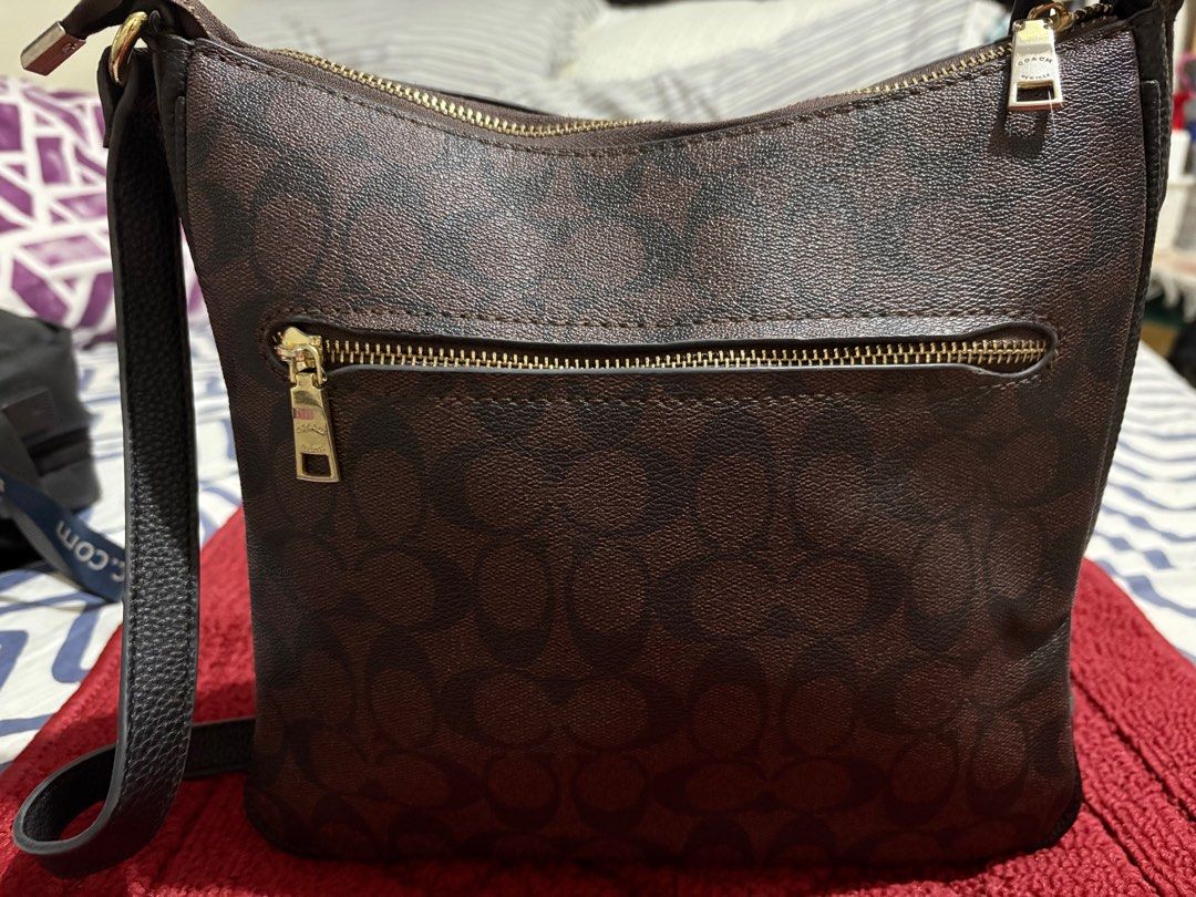 Val Duffle Bag In Signature Canvas (Category: Shoulder Bags) located in San Juan City. Submitted by quickpenguin.0016e7 (Listing ID 1387264284, Image 3). Description: Val Duffle Bag In Signature Leather Trims Color: Gold / Walnut Black Bag Width: Medium (9”) Refined pebble leather| Signature coated canvas and refined pebble leather| Inside zip, cell phone and multifunction pockets| Zip-top closure, fabric lining| Outside zip pocket| Adjustable st