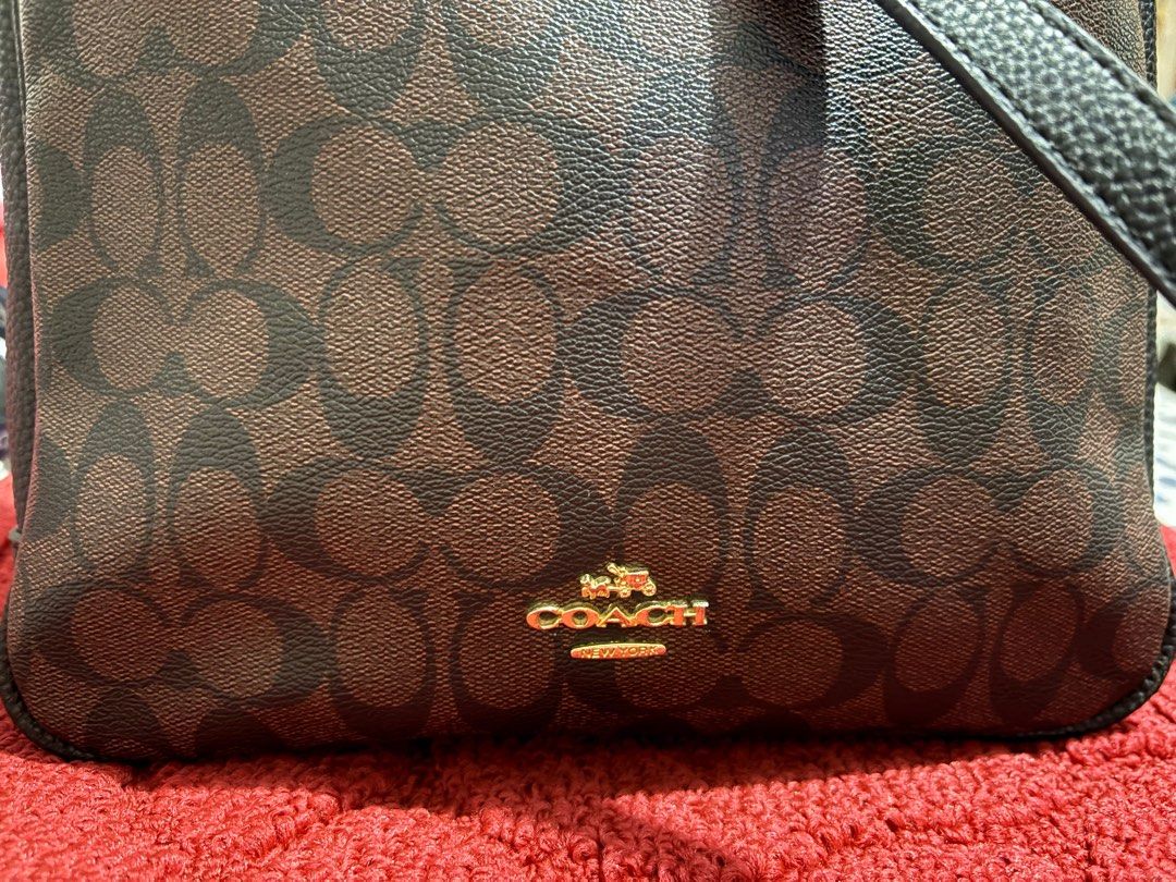 Val Duffle Bag In Signature Canvas (Category: Shoulder Bags) located in San Juan City. Submitted by quickpenguin.0016e7 (Listing ID 1387264284, Image 2). Description: Val Duffle Bag In Signature Leather Trims Color: Gold / Walnut Black Bag Width: Medium (9”) Refined pebble leather| Signature coated canvas and refined pebble leather| Inside zip, cell phone and multifunction pockets| Zip-top closure, fabric lining| Outside zip pocket| Adjustable st