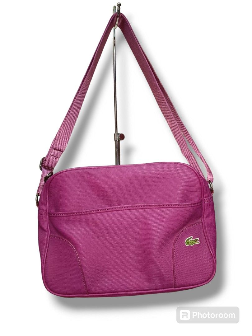 PreLoved Lacoste Sling Bag in Magenta (Category: Cross-body Bags) located in Paranaque City. Submitted by mscath.varietyshop (Listing ID 1387436663, Image 1). Description: wysiwyg as is actual photos posted flaws indicated in photos(if any).