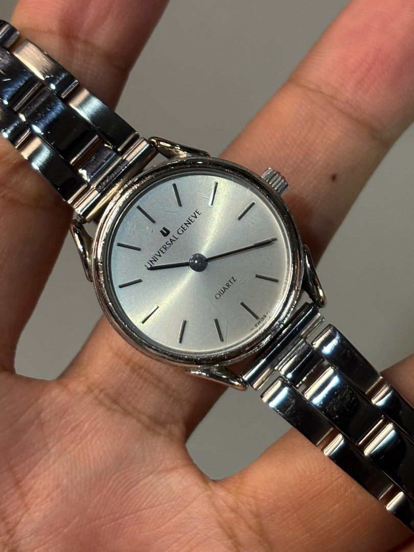 Universal Genève White Sunburst Dial Quartz (Category: Luxury Watches) located in Manila. Submitted by soughtafterseconds (Listing ID 1387407139, Image 2). Description: Universal Genève White Sunburst Dial Quartz This vintage Universal Genève quartz watch exudes understated sophistication. Featuring a crisp sunburst white dial, minimalist stick indices, and a polished stainless steel case and bracelet, it’s a refined timepiece perfect for everyda