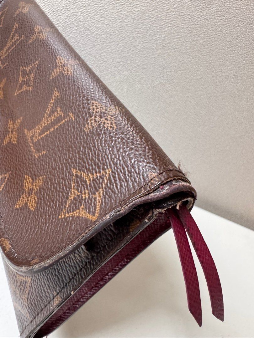 AUTHENTIC Louis Vuitton Emilie Wallet in Monogram Canvas (Category: Luxury Bags & Wallets) located in Makati City. Submitted by makayshoppe (Listing ID 1387596552, Image 3). Description: Well used but still gorgeous LV Emilie wallet, with initials. Guaranteed authentic, purchased years ago in LV Greenbelt. Leather is okay, no cracking in the inside pockets, no sticky pockets. Obvious signs of daily usage, minor stitches on the side are coming off