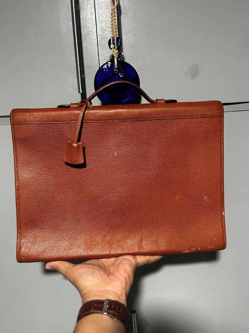Gianfranco Ferre Leather clutch Document Bag (Category: Luxury Bags & Wallets) located in Esperanza. Submitted by mindanaothriftshop (Listing ID 1387587379, Image 2). Description: Excellent Condition FREE SHIPPING Self Authentication Like new condition Issues: 1. Paint Marks (not sure if removable) - have not tried removing it 2. Missing key - not sure if brand new comes with a key 3. Available for shipping in friday 10/10 Color Rate.