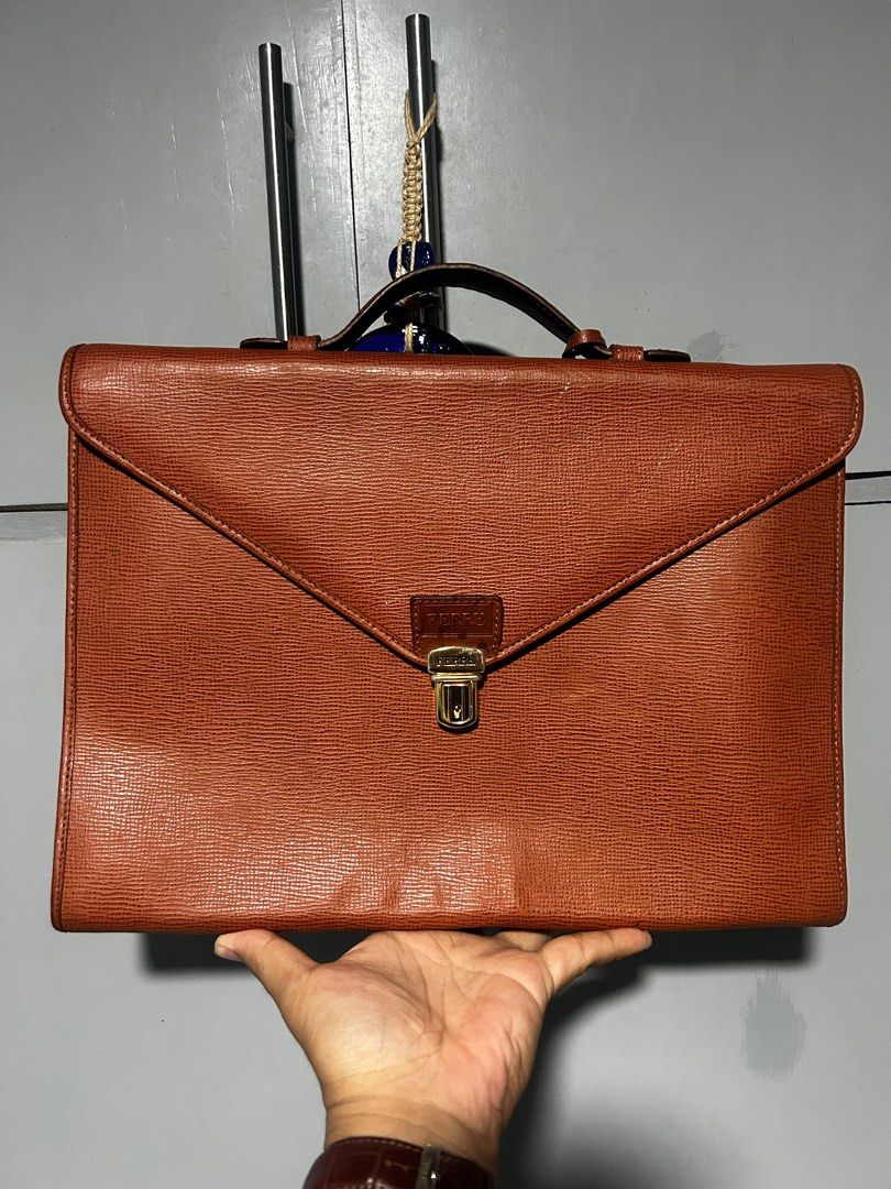Gianfranco Ferre Leather clutch Document Bag (Category: Luxury Bags & Wallets) located in Esperanza. Submitted by mindanaothriftshop (Listing ID 1387587379, Image 1). Description: Excellent Condition FREE SHIPPING Self Authentication Like new condition Issues: 1. Paint Marks (not sure if removable) - have not tried removing it 2. Missing key - not sure if brand new comes with a key 3. Available for shipping in friday 10/10 Color Rate.