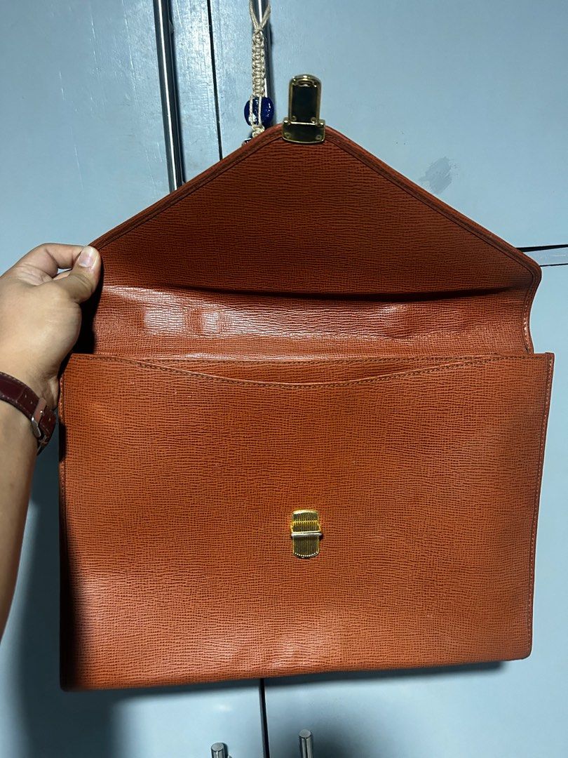 Gianfranco Ferre Leather clutch Document Bag (Category: Luxury Bags & Wallets) located in Esperanza. Submitted by mindanaothriftshop (Listing ID 1387587379, Image 3). Description: Excellent Condition FREE SHIPPING Self Authentication Like new condition Issues: 1. Paint Marks (not sure if removable) - have not tried removing it 2. Missing key - not sure if brand new comes with a key 3. Available for shipping in friday 10/10 Color Rate.