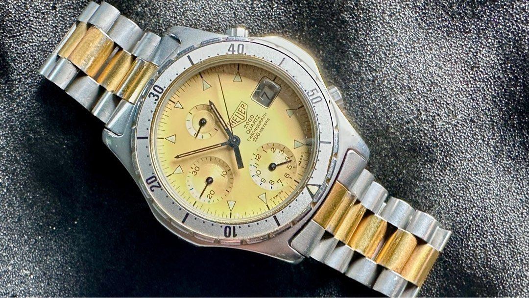 Heuer 2000 2-tone quartz chronograph (Category: Luxury Watches) located in Manila. Submitted by olxph_400275733 (Listing ID 1387630794, Image 1). Description: 37mm width. 2-tone with original signed bracelet. Rare pre-Tag variant..
