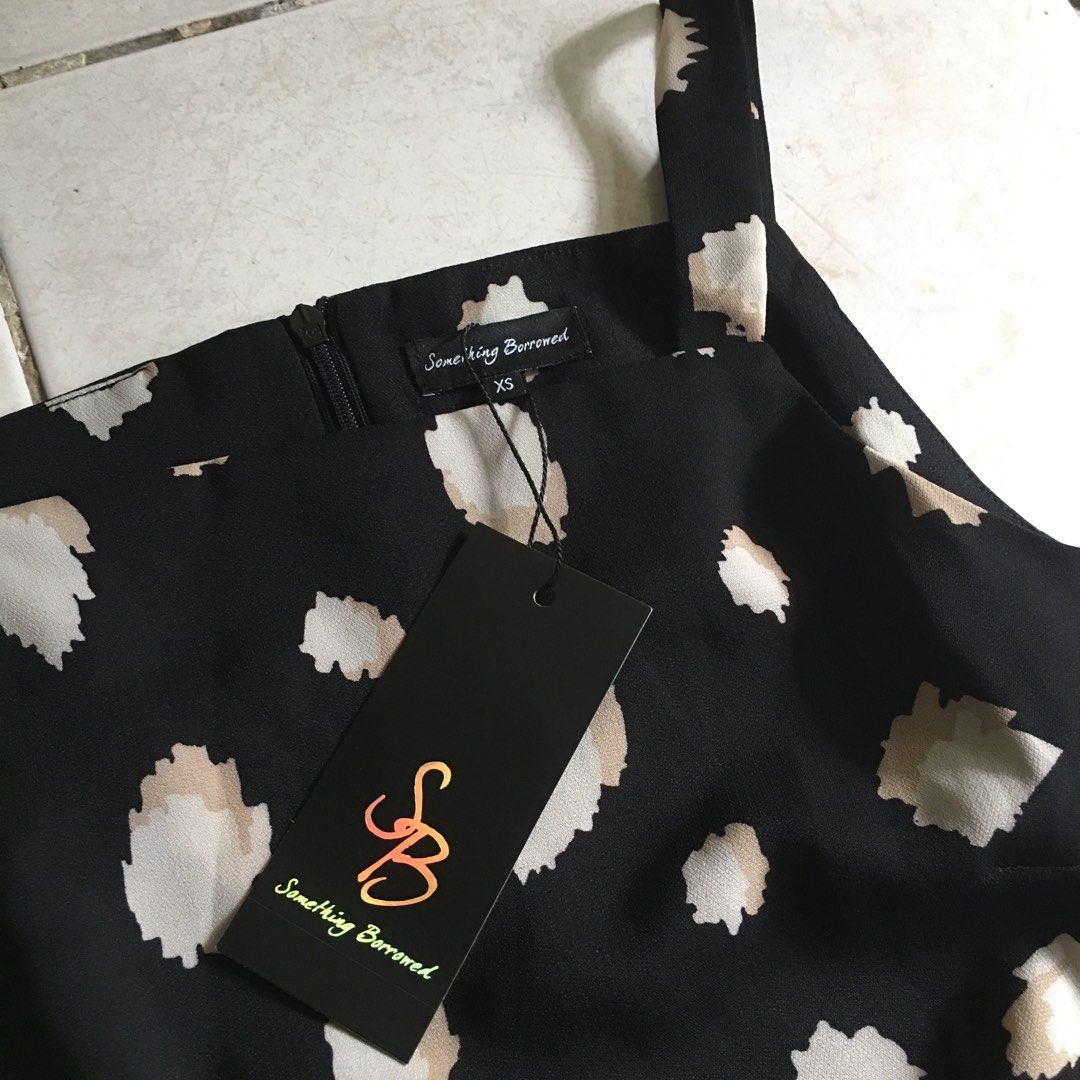 Something Borrowed Dress (Category: Dresses) located in Dagupan City. Submitted by einalem.declutters (Listing ID 1387611972, Image 2). Description: Brand: Something Borrowed Size: XS Dress Design: Black with geometric-ish floral design with ruffles on bottom, zipper on the back Condition: never been used, with tag on Mop: gcash/maya Mod: j&t/lbc Buyer will shoulder the shipping fee Send a message if interested .