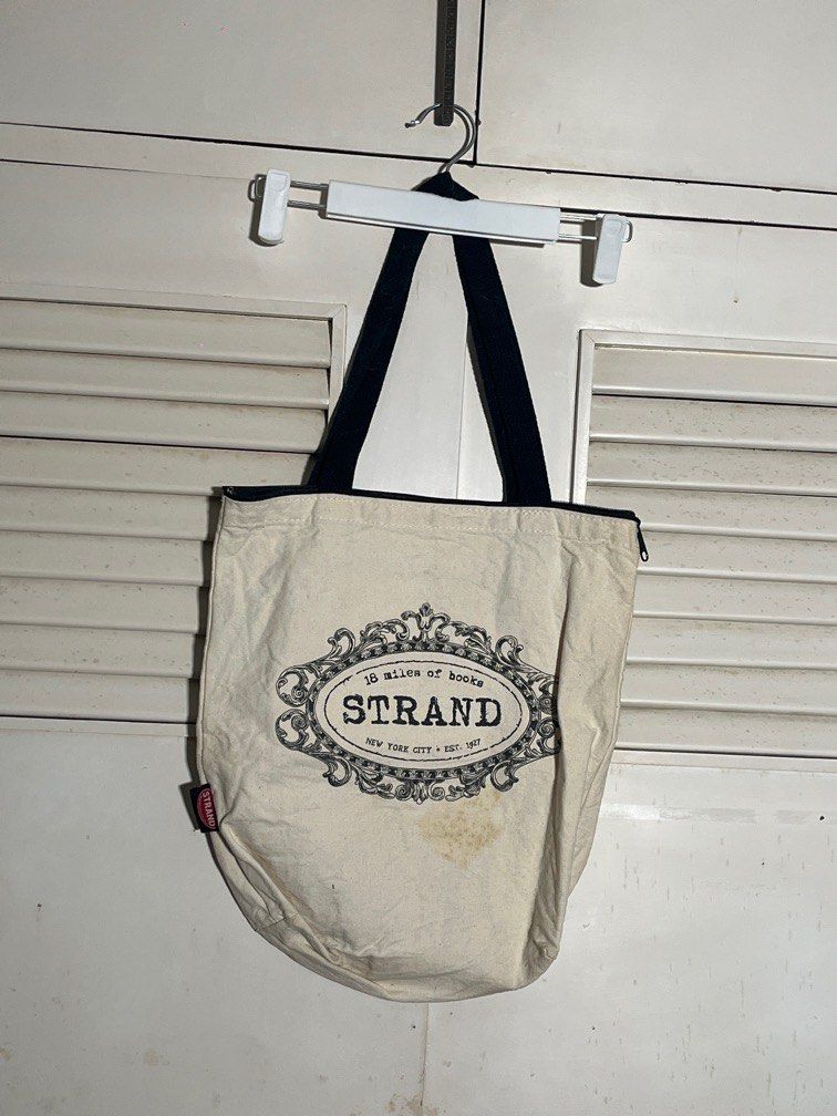 strand bookstore NY tote bag (Category: Tote Bags) located in Pasig City. Submitted by joey_b (Listing ID 1387670590, Image 1). Description: as is. some stains. can maybe we washed out 🤷🏽‍♀️ purchased from the Strand bookstore in New York pocket and zipper close.