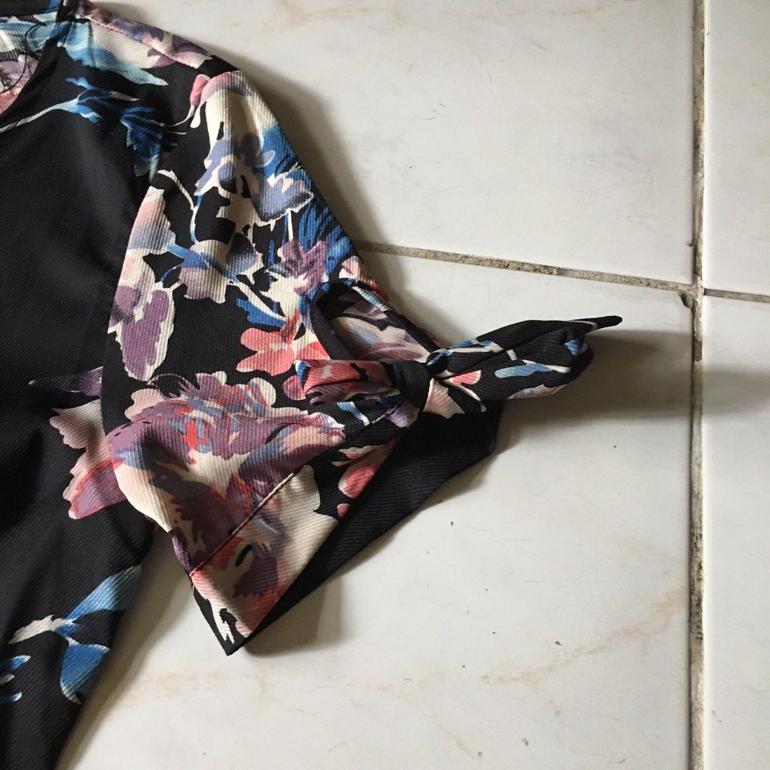 Zalora floral wrap dress (Category: Dresses) located in Dagupan City. Submitted by einalem.declutters (Listing ID 1387616263, Image 2). Description: Brand: Zalora Size: XS Dress Design: black, floral pattern, ribbon on sleeves and waist, wrap dress Condition: dresses are used once or never been used, personally sewn clip button on neckline (see picture) Mop: gcash/maya Mod: j&t/lbc Buyer will shoulder the shipping fee Send a message if interested