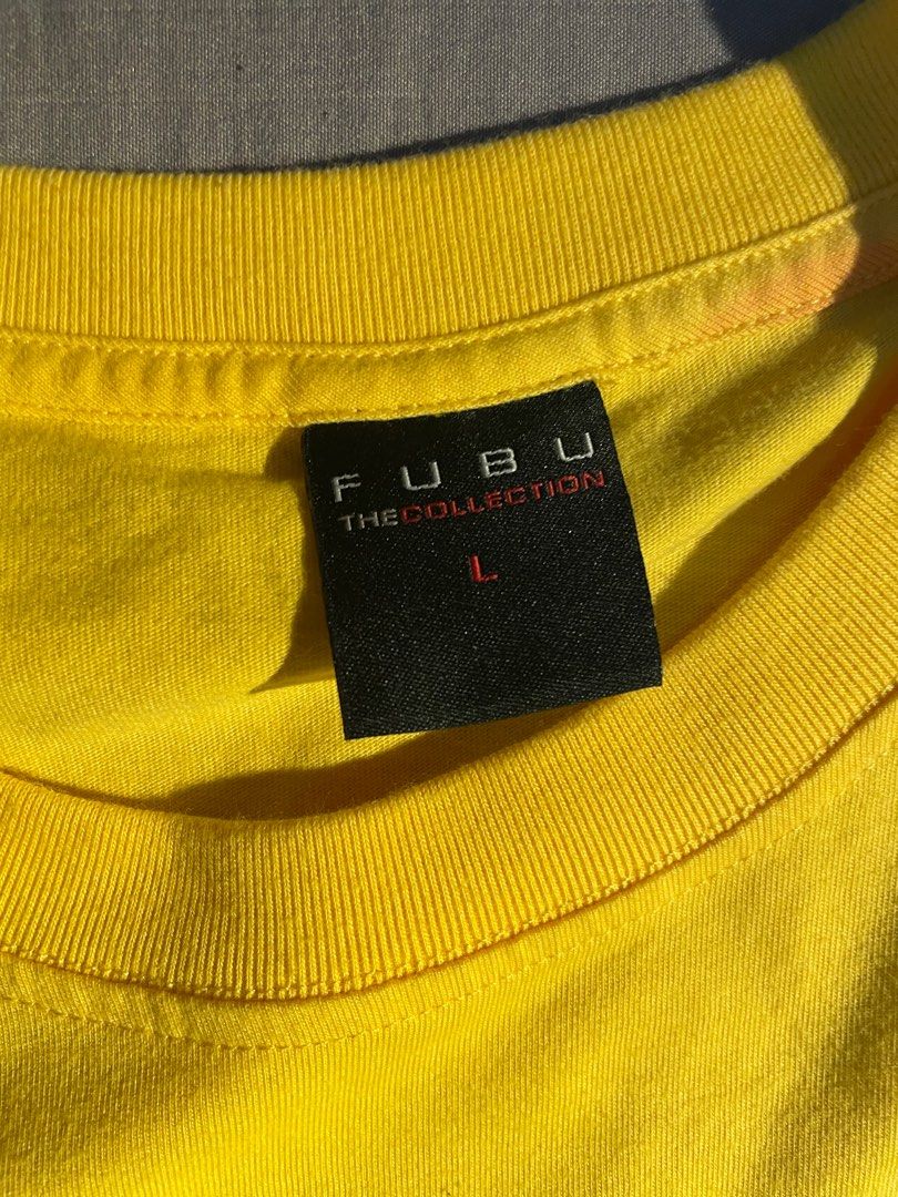 FUBU TSHIRT 2000s style (Category: Tshirts & Polo Shirts ) located in Makati City. Submitted by berto01 (Listing ID 1384409236, Image 3). Description: FUBU TSHIRT VERY GOOD CONDITION no issues Yellow color rate 10/10 L on tag .