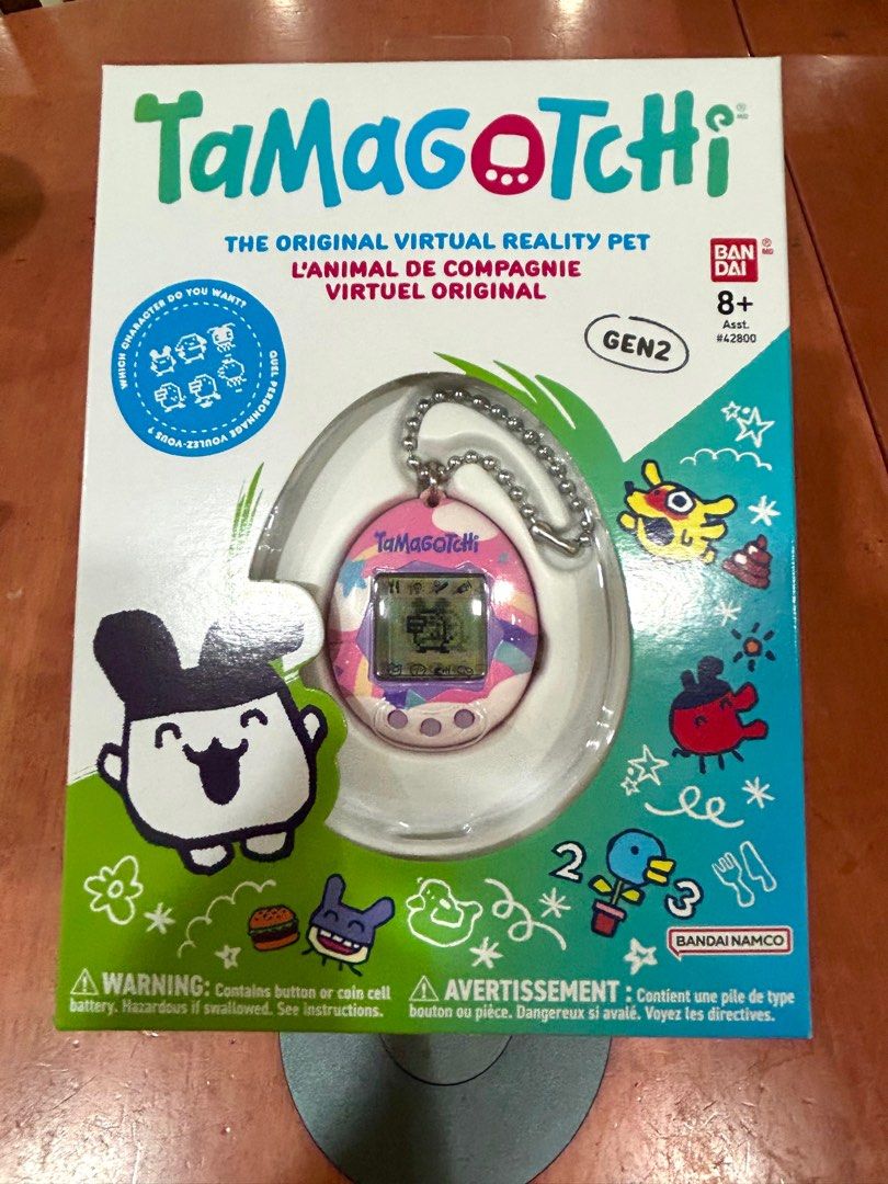 Tamagotchi Gen 2 Dreamy Shell Virtual Pet (Category: Interactive Toys) located in Singapore. Submitted by orinoco (Listing ID 1384375828, Image 1). Description: - Tamagotchi Gen 2 Dreamy Shell. - Comes with original packaging. - Perfect for kids and collectors. - Very pretty pink shell featuring stars, rainbow and clouds.