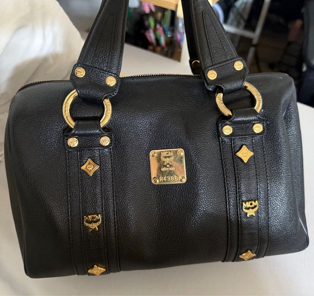 MCM black leather gold studded boston bag (Category: Luxury Bags & Wallets) located in Muntinlupa City. Submitted by bashabells (Listing ID 1387799048, Image 1). Description: Used only once and in excellent condition.