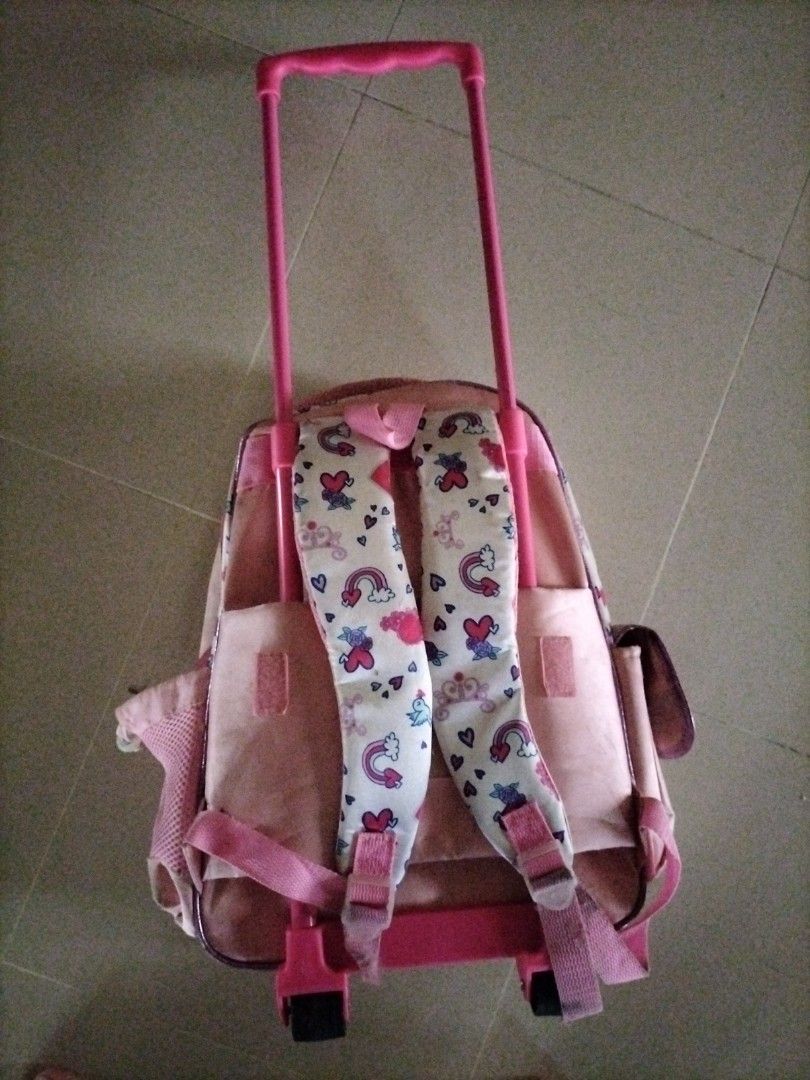 Sofia the First Rolling Backpack (Category: Backpacks) located in Singapore. Submitted by skullman031977 (Listing ID 1387753286, Image 2). Description: - Adorable Sofia the First rolling backpack. - Perfect for young children. - Features a pull-up handle and wheels. - Can be used as a regular backpack. - Includes a main compartment and side pockets..
