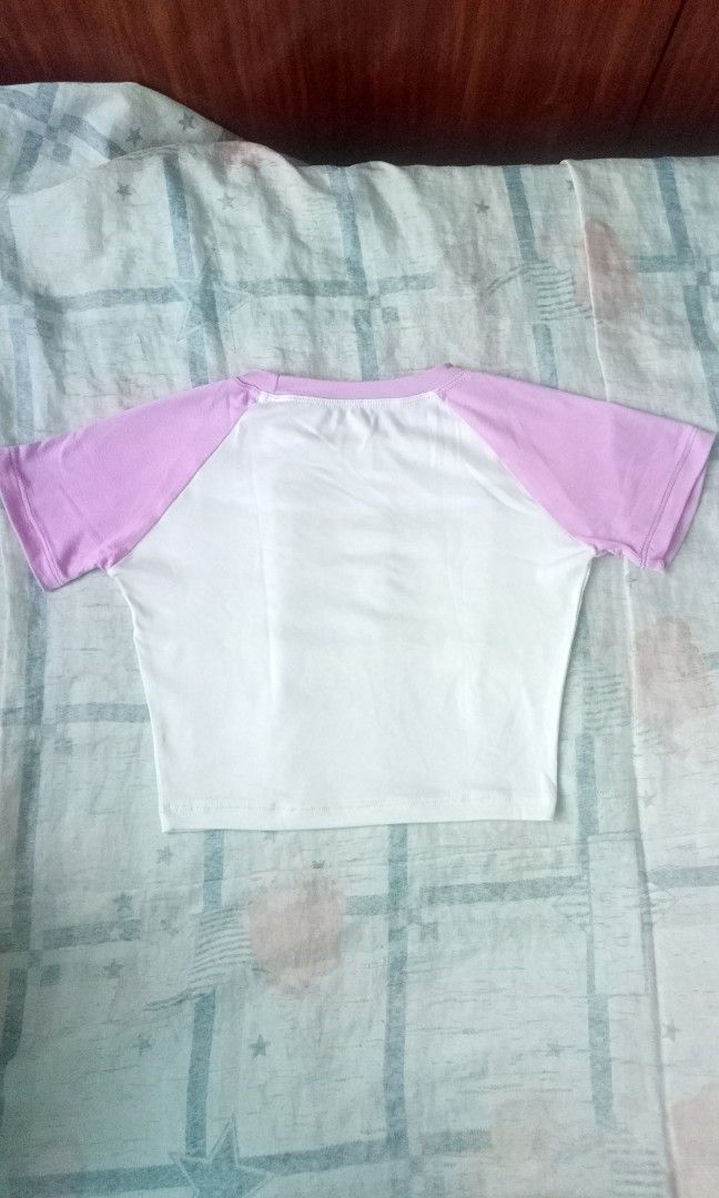 Baddie Pink Dragon Y2K Crop Top (Category: Shirts) located in Manila. Submitted by peterparkedcar (Listing ID 1388007995, Image 2). Description: Baddie Pink Dragon Y2K Crop Top 👕 Description: very soft, ringer tee with pink sleeves and collar 👕 Condition: like new! bought and never worn 🛍️ Reason for Selling: doesn't fit my style 🛍️ Place of Origin: bought from orange app 🚛 Mode of Transaction: Delivery, Meetup 🚛 Delivery Options: Lalamove,