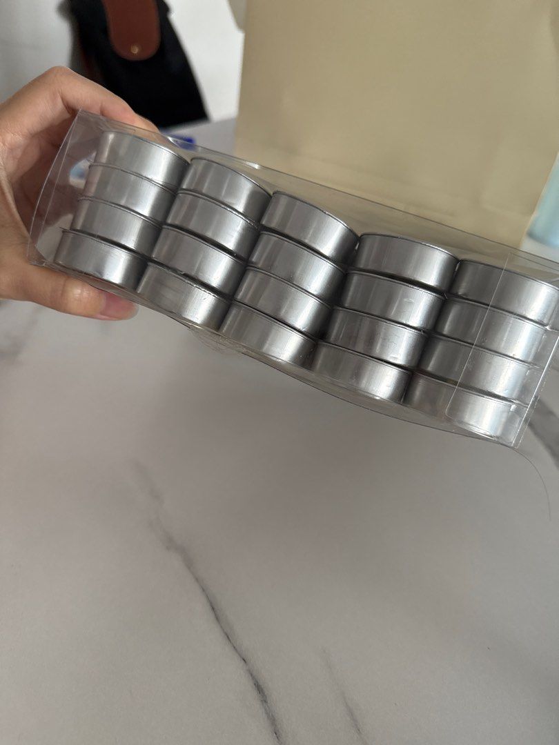 CB2 Tea Light Candles - New (Category: Home Fragrance) located in Singapore. Submitted by shopperbby (Listing ID 1387968730, Image 1). Description: - New, unopened box of CB2 tea light candles. - Contains 24 candles (used 2 and left 22) - Each candle has a silver casing. - Perfect for creating a cozy atmosphere. - Price: $30.