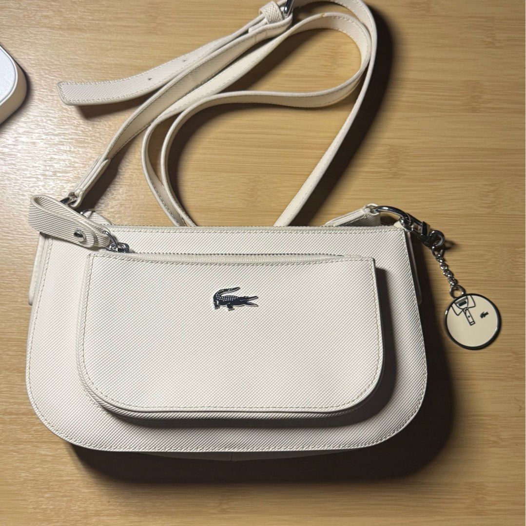 Authentic Lacoste Sling Bag (Category: Luxury Bags & Wallets) located in Binan City. Submitted by sunnysprelovedcollection (Listing ID 1388110397, Image 1). Description: Authentic Lacoste Sling Bag Pristine condition Lightly used Looks new to me Used twice With original Lacoste Bag charm With original lacoste paper bag Spare bag.