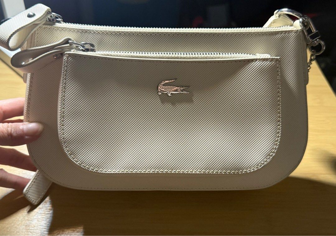 Authentic Lacoste Sling Bag (Category: Luxury Bags & Wallets) located in Binan City. Submitted by sunnysprelovedcollection (Listing ID 1388110397, Image 3). Description: Authentic Lacoste Sling Bag Pristine condition Lightly used Looks new to me Used twice With original Lacoste Bag charm With original lacoste paper bag Spare bag.