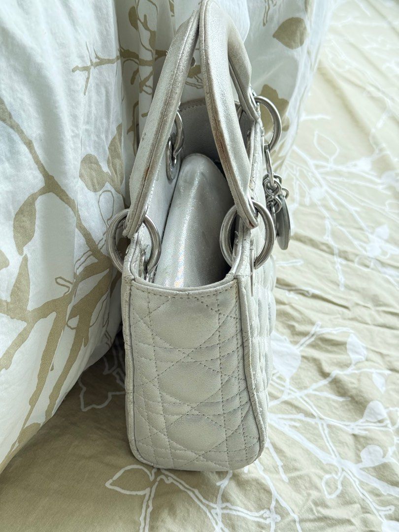 Lady Dior (Category: Luxury Bags & Wallets) located in Mandaue City. Submitted by melbafelis47966 (Listing ID 1388117207, Image 3). Description: 2019 Mini Metallic Lambskin Cannage Lady Dior satchel Made in Italy Highlights quilted lambskin leather body flat leather top handles coded detachable chain-link strap with leather shoulder guard fold-in flap closure interior zip pocket gray Outer: Lambskin 100%.