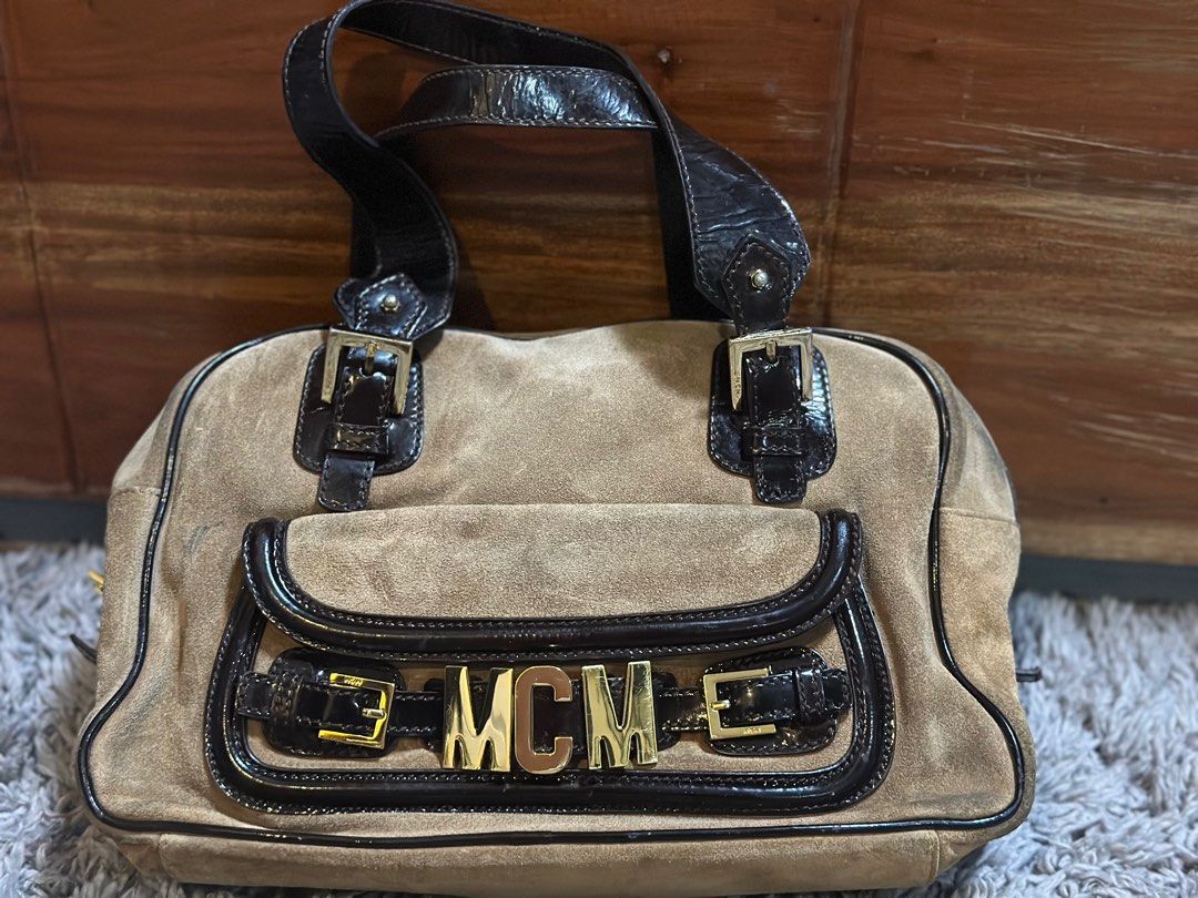 MCM Boston/Duffle Bag (Category: Luxury Bags & Wallets) located in Quezon City. Submitted by donaya_luxe (Listing ID 1388291577, Image 1). Description: Body of the bag is a Suede Material while the handles and other linings is patent leather Since this is a vintage bag ,the suede shows signs of usage & dirt which can be cleaned. Flaws are shown in the pics for your reference Overall this bag is presentable .