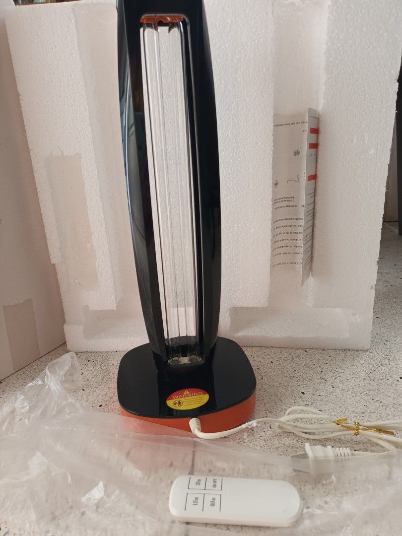 UV light (Category: Other Home Appliances) located in Singapore. Submitted by gogay (Listing ID 1388211713, Image 1). Description: - Sleek, modern design in black and orange. - Includes a convenient remote control for easy operation. - Used but in good condition. - Ideal for disinfecting and purifying your space..