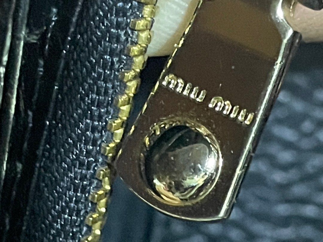 Miu Miu Wallet on Chain (Category: Luxury Bags & Wallets) located in Rosario. Submitted by myvinatgepieces (Listing ID 1388424647, Image 3). Description: Miu Miu Wallet on Chain Crafted with black grained leather Multi Card slots Flap Closure One Zipper Compartment Excellent Used Condition With Minor Sign of Wear No Other Inclusions Selling as is.