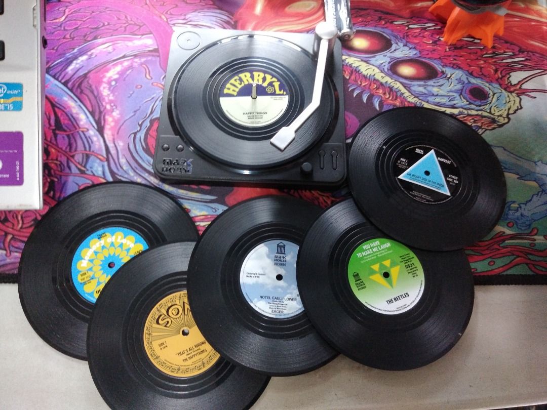 Novelty Vinyl Coasters (Category: Coffee & Tea Tableware) located in Las Pinas. Submitted by hppyclttrc0. (Listing ID 1388343821, Image 1). Description: -These coasters are designed to look like vinyl records and come with a holder resembling a record player. -Very decorative and ideal gift for music lovers. Can add a nostalgic touch to any setting. -Box included [Packaging has tears/dents/creases, but item itself is unused and in perfect conditi