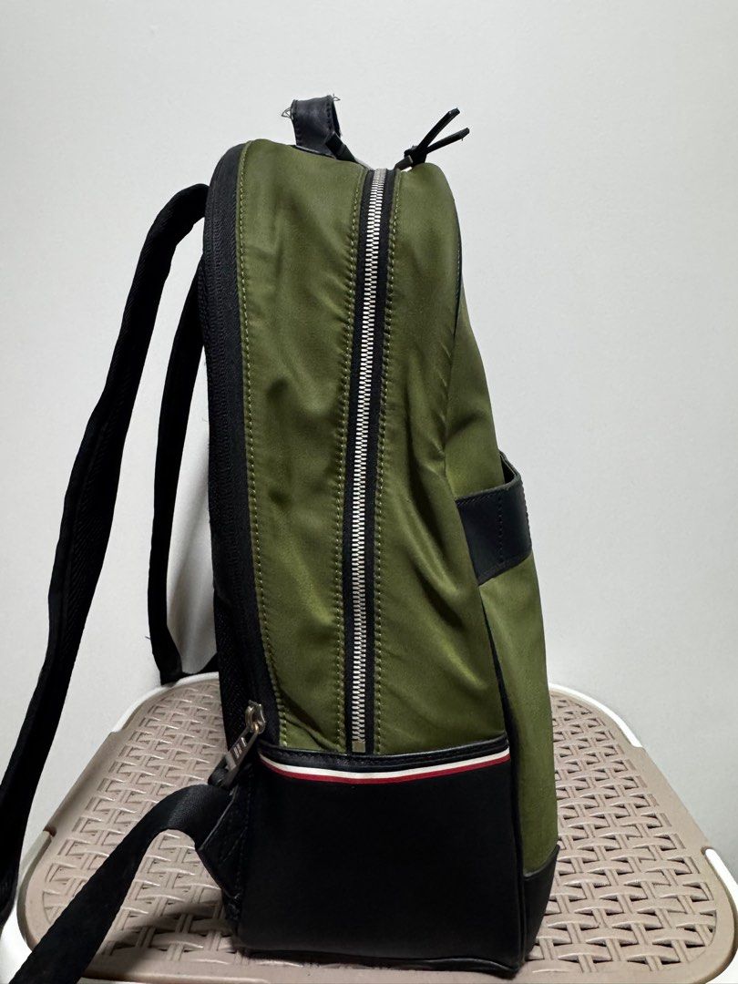 Original Tommy Hilfiger Backpack (Category: Backpacks) located in Dasmarinas. Submitted by JD1997 (Listing ID 1388318015, Image 3). Description: This is an original Tommy Hilfiger Backpack in army green color. A combination of Nylon and Leather material with metal-attached TH-spelled out logo. This bag has laptop compartment that can fit up to 15 inches. with in-pocket inside. Honest issues: - minor zipper discoloration (unnoticeable) - leather s