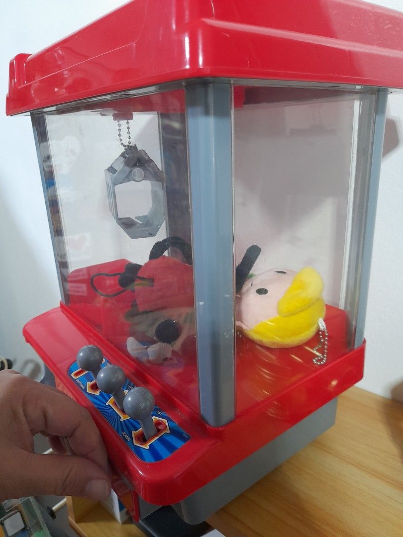 CLAW machine (Category: Interactive Toys) located in Agdangan. Submitted by csdepot (Listing ID 1388866688, Image 3). Description: Working well 12inches x 6inches (estimate) with free small stuff toys inside with token with batteries Bought from the US With FREE stuffies (4pcs) *Check images before asking pls RFS: decluttering.