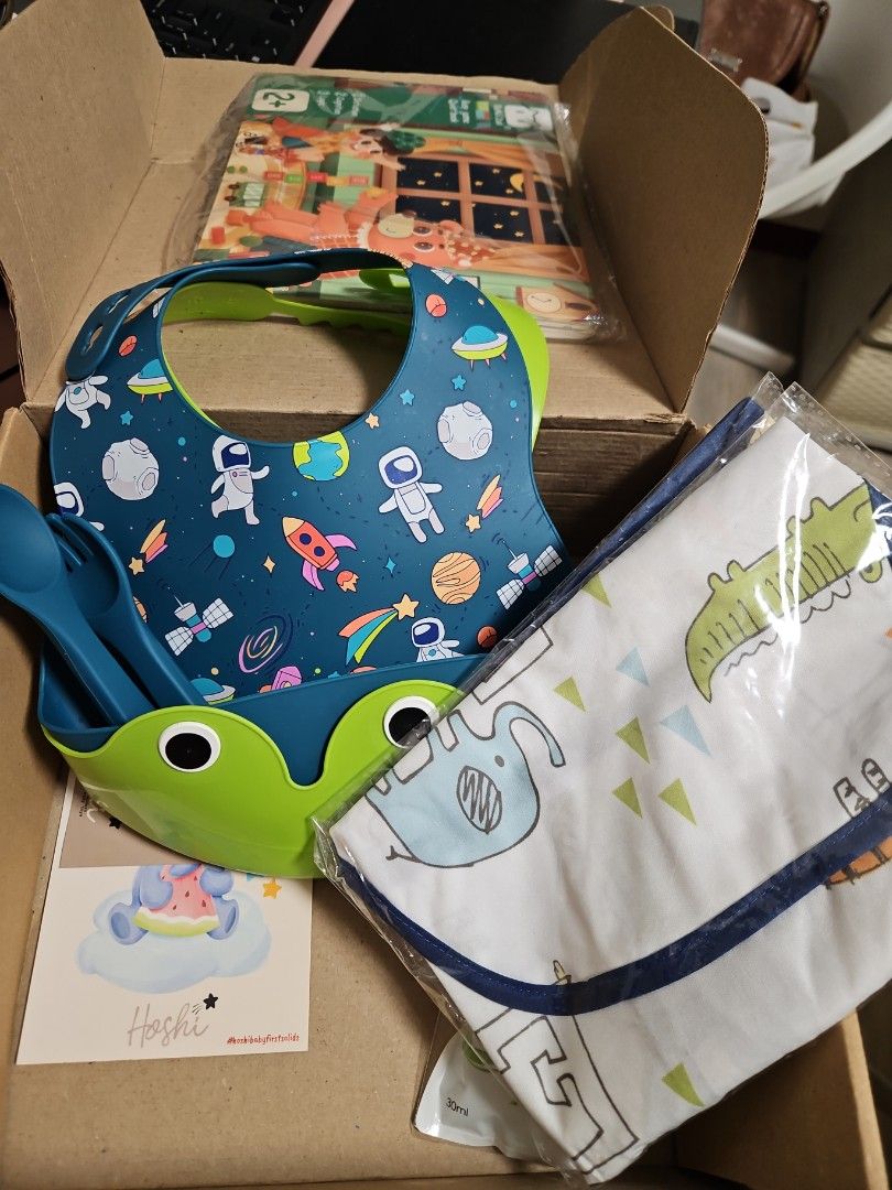 Feeding bibs (Category: Weaning & Toddler Feeding) located in Quezon City. Submitted by iamyumiiiii (Listing ID 1388702081, Image 1). Description: unused bibs (3pcs), unused spoon and fork, unused busy book.