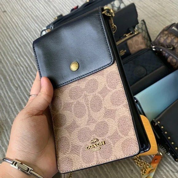 Coach Phone/Card Sling (Category: Luxury Bags & Wallets) located in Baguio. Submitted by thrift_saver07 (Listing ID 1388940646, Image 2). Description: Signature coated canvas and refined calf leather Snap closure Four outside credit card slots Detachable strap with 23" drop for shoulder or crossbody wear 4 1/4" (L) x 7" (H) x 1 1/4" (W) Style No. 76357.