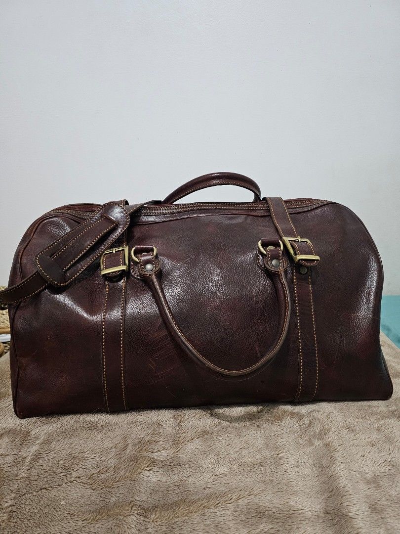 Dark Brown Genuine Leather Weekender Duffle Bag (Category: Luxury Bags & Wallets) located in Quezon City. Submitted by jayjiess (Listing ID 1388949424, Image 2). Description: Dimensions: Length: 20inches Width / Depth: 10inches Height: 12inches - genuine Italian leather, dark brown, thick and glossy - bottom metal feet - spacious compartment - comfortable shoulder strap - with additional leather strap buckle closure buyer shoulders s/f.