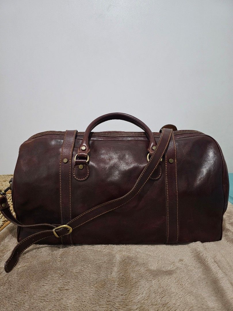 Dark Brown Genuine Leather Weekender Duffle Bag (Category: Luxury Bags & Wallets) located in Quezon City. Submitted by jayjiess (Listing ID 1388949424, Image 3). Description: Dimensions: Length: 20inches Width / Depth: 10inches Height: 12inches - genuine Italian leather, dark brown, thick and glossy - bottom metal feet - spacious compartment - comfortable shoulder strap - with additional leather strap buckle closure buyer shoulders s/f.