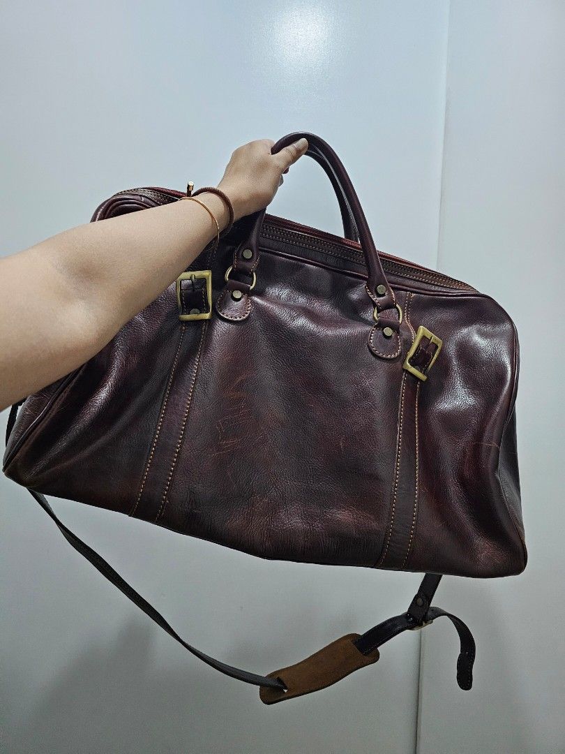 Dark Brown Genuine Leather Weekender Duffle Bag (Category: Luxury Bags & Wallets) located in Quezon City. Submitted by jayjiess (Listing ID 1388949424, Image 1). Description: Dimensions: Length: 20inches Width / Depth: 10inches Height: 12inches - genuine Italian leather, dark brown, thick and glossy - bottom metal feet - spacious compartment - comfortable shoulder strap - with additional leather strap buckle closure buyer shoulders s/f.