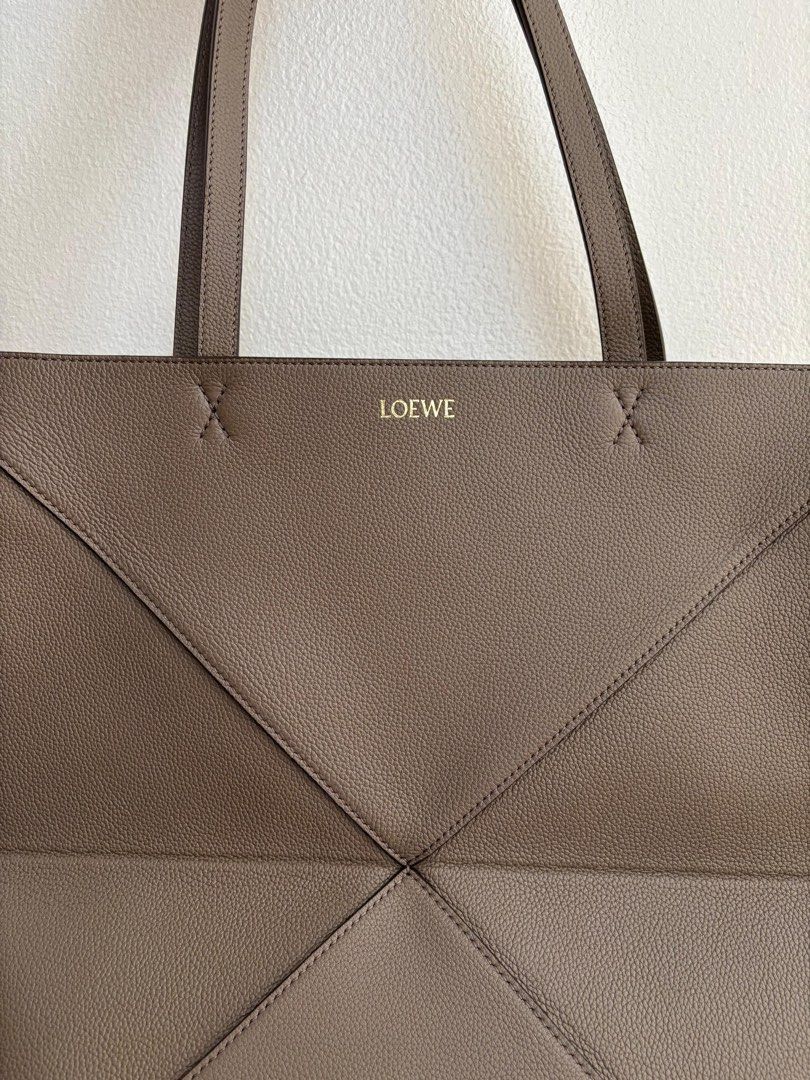 Loewe Medium Puzzle Fold Tote (Category: Luxury Bags & Wallets) located in Mandaluyong City. Submitted by margabell (Listing ID 1388960299, Image 1). Description: For Sale Brand New Loewe Medium Puzzle Fold Tote Soft Grained Calf Skin (Non-Shiny Leather) Taupe Color Complete Inclusions such as Authentication Certificate & Dust Bag Bought in the United Kingdom (UK) .
