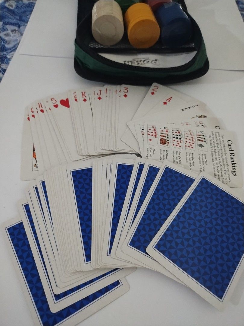 POKER- CARDS GAME SET WITH CHIPS AND BAG (Category: Board Games & Puzzles) located in Paranaque City. Submitted by maapolonio (Listing ID 1389017886, Image 2). Description: a deck of cards in excellent condition with 5 different colors of stacks of chips and a bag to hold the cards and chips.