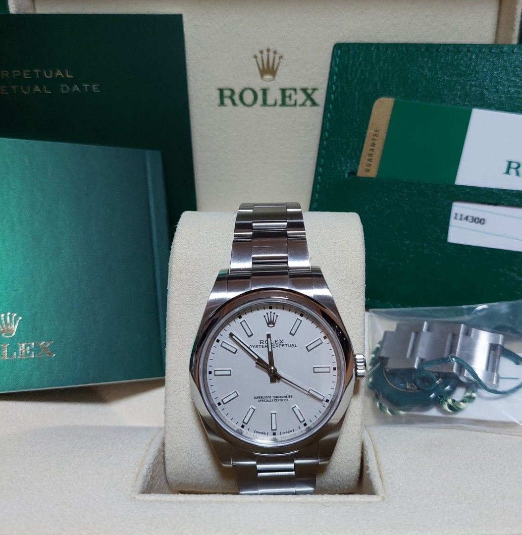 Rolex Oyster Perpetual 114300 White Dial (Category: Watches) located in Singapore. Submitted by saudiboy_19 (Listing ID 1389088799, Image 1). Description: Rolex Oyster Perpetual 39 – Ref. 114300 White Dial Lightly used and seldom worn, in excellent working condition. This is the clean and highly sought-after white dial version, discontinued and harder to find today. ✅ Complete full set – box, papers, warranty card, green & white tags, extra links