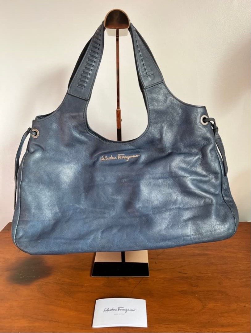 Salvatore Ferragamo Leather Hobo bag (Category: Luxury Bags & Wallets) located in Muntinlupa City. Submitted by secondemain.ph (Listing ID 1389040771, Image 3). Description: •Color: Blue •100% Leather (Made in Italy) • Snap closure •Silver hardware •15” L x 3.75” W x 10” H. 9.5” Strap drop •Inclusions: 9.8/10 BRAND NEW but stored for a few years. With a little musty smell but can be easily removed. Comes with original salvatore ferragamo dust bag