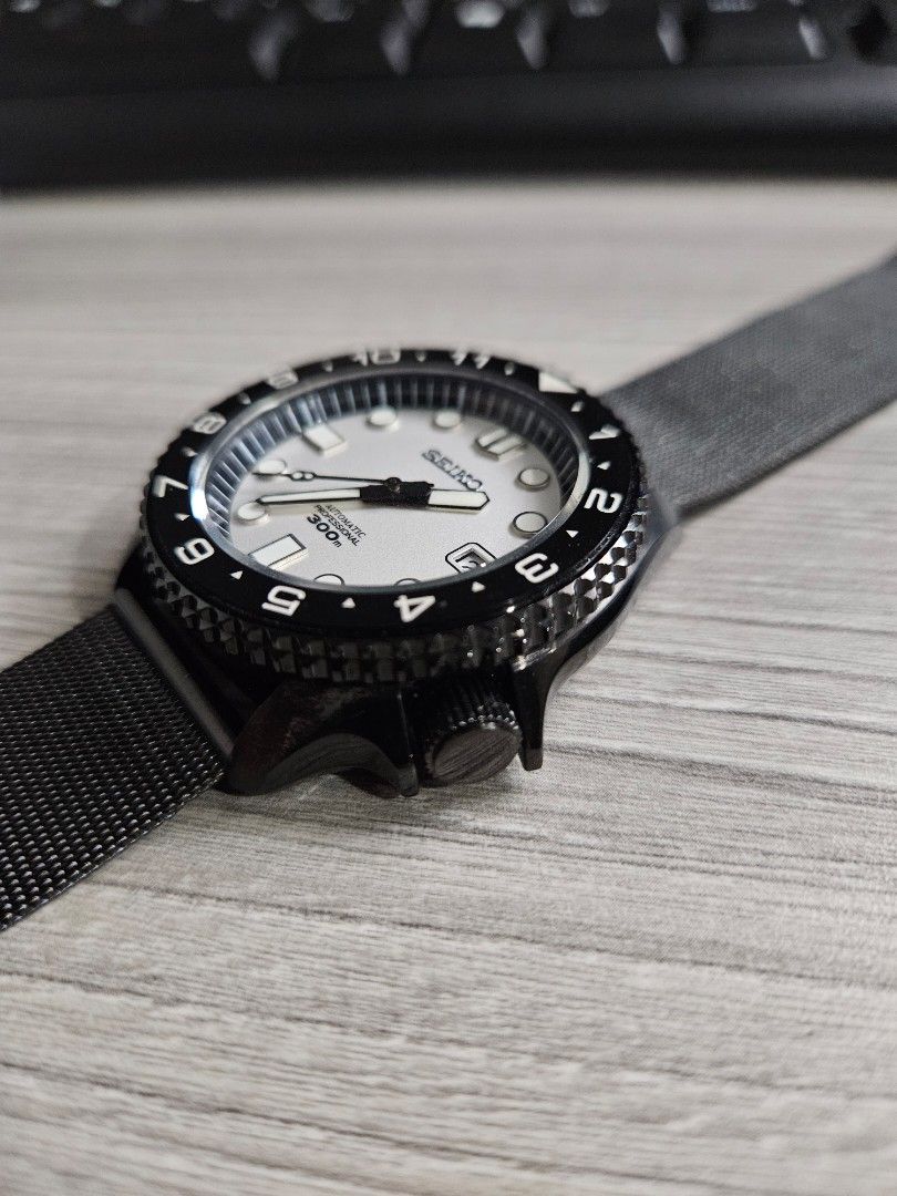 Seiko SKX stealth mod (Category: Men's Watches) located in San Juan City. Submitted by integrale (Listing ID 1388966485, Image 3). Description: NH35 movement, dial, hands, ceramic bezel insert from Watch and Style LZD case, crown, caseback aftermarket mesh bracelet.