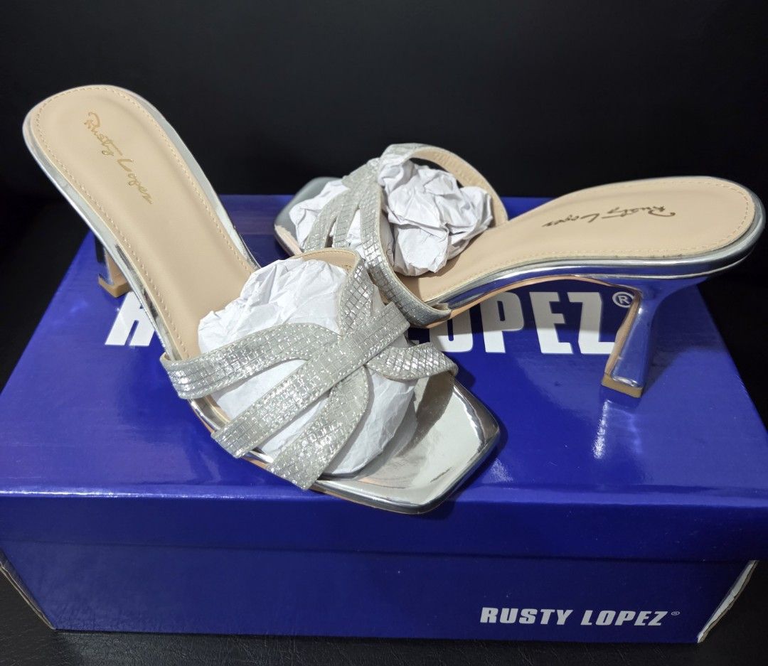 Rusty Lopez Silver Heels (Category: Heels) located in General Trias. Submitted by ClutterCrunch (Listing ID 1389199438, Image 1). Description: Rusty Lopez Ladies Heeled Step in (Lori) Slip on (easy to on and off the bare foot) Cross bond strap and accent of patent materials. Size 6 (36). Used once for a wedding. Shipping c/o buyer, thru lalamove or J&T. MOP: GCash/BDO RFS: for medication costs. Location: General Trias, Cavite Thank you!.