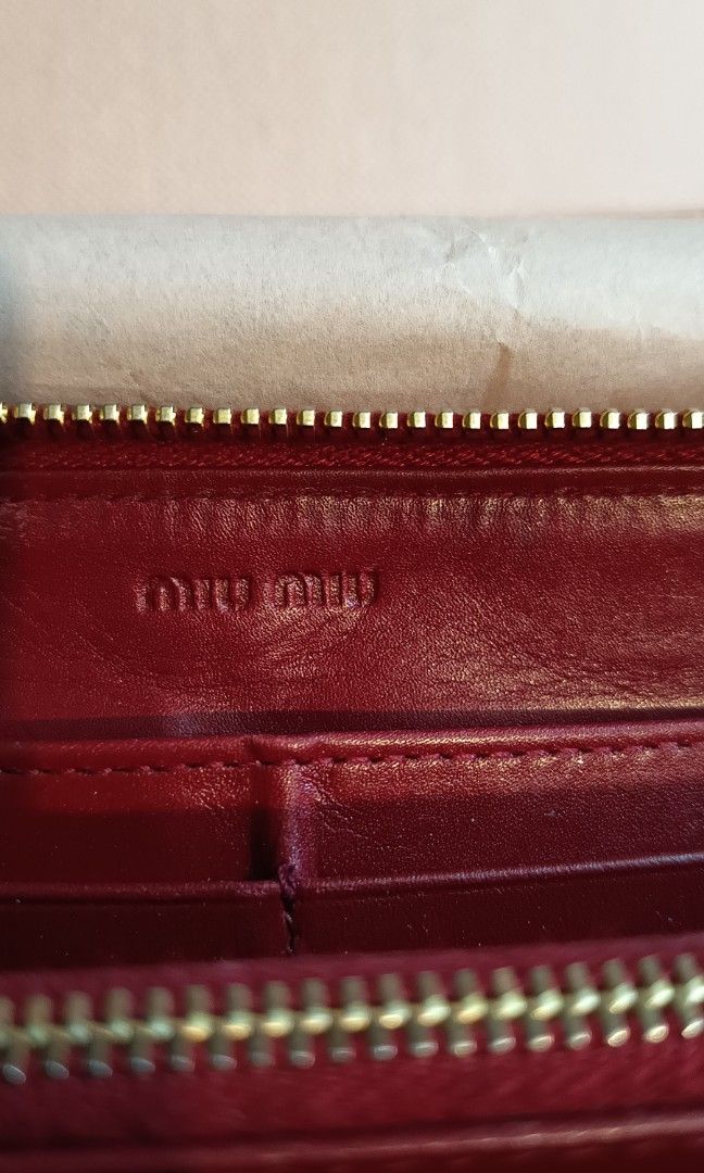 Authentic Miu Miu Red Croc Embossed Leather Zip Around Wallet (Category: Luxury Bags & Wallets) located in Binangonan. Submitted by retrovintagesourceph (Listing ID 1389381726, Image 3). Description: This wallet from Miu Miu is one creation a fashionista like you must own. It has been wonderfully crafted from croc-embossed leather and it flaunts a red shade. It also comes equipped with a zip around that opens to reveal multiple slots and a zipper