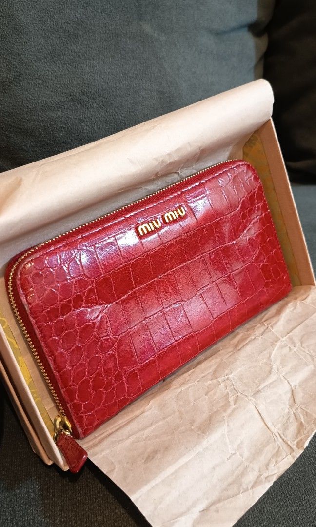 Authentic Miu Miu Red Croc Embossed Leather Zip Around Wallet (Category: Luxury Bags & Wallets) located in Binangonan. Submitted by retrovintagesourceph (Listing ID 1389381726, Image 2). Description: This wallet from Miu Miu is one creation a fashionista like you must own. It has been wonderfully crafted from croc-embossed leather and it flaunts a red shade. It also comes equipped with a zip around that opens to reveal multiple slots and a zipper