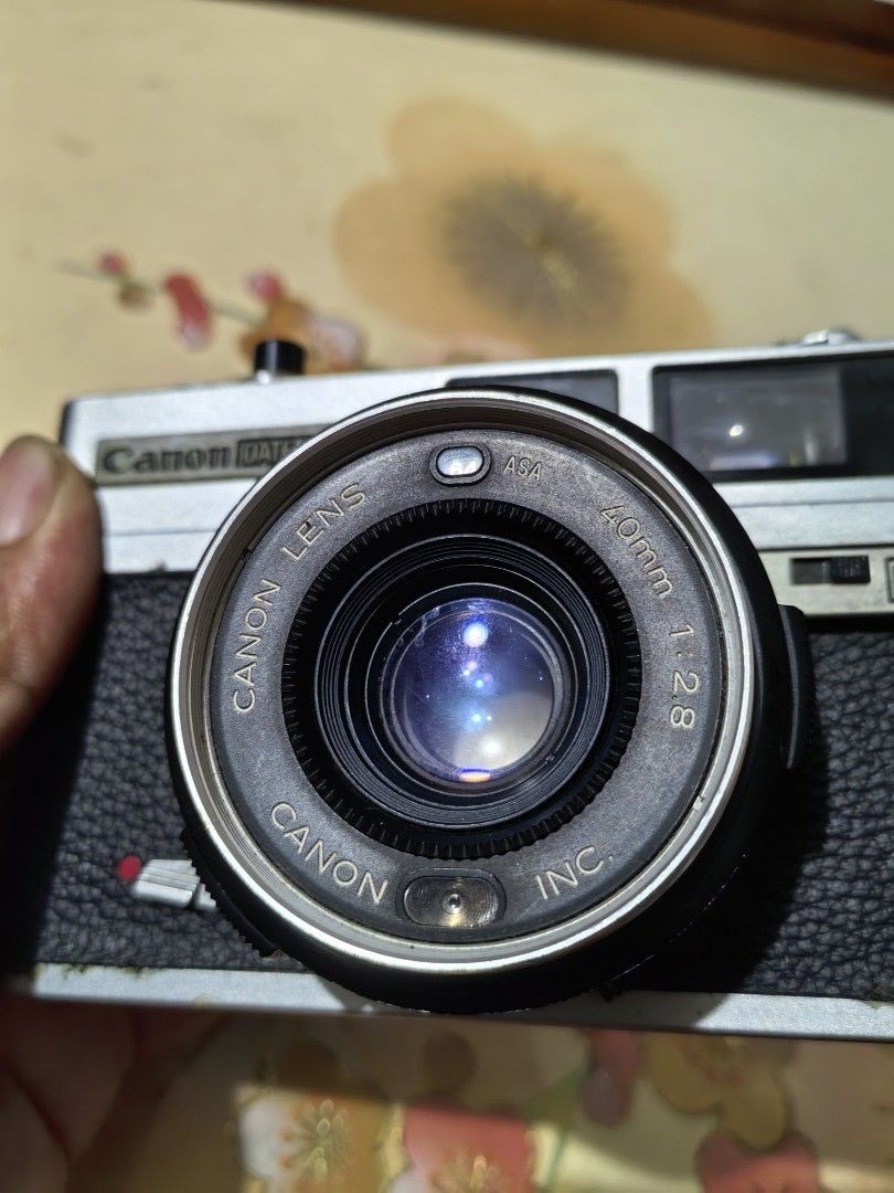 Canon Datematic Camera (Category: Cameras) located in Cebu City. Submitted by dudes_villanueva (Listing ID 1389558824, Image 3). Description: Canon Datematic Note: Not Working. Film Lever stuck. Foam Seal brittle. Rangefinder has tiny dust. Camera Lens on good condition. Sold as is. All sales final and Non-refundable. 📌A compact 35mm rangefinder camera released in 1974. 📌It features programmed autoexposure and a 40mm f/2.8 lens. 📌A key feature