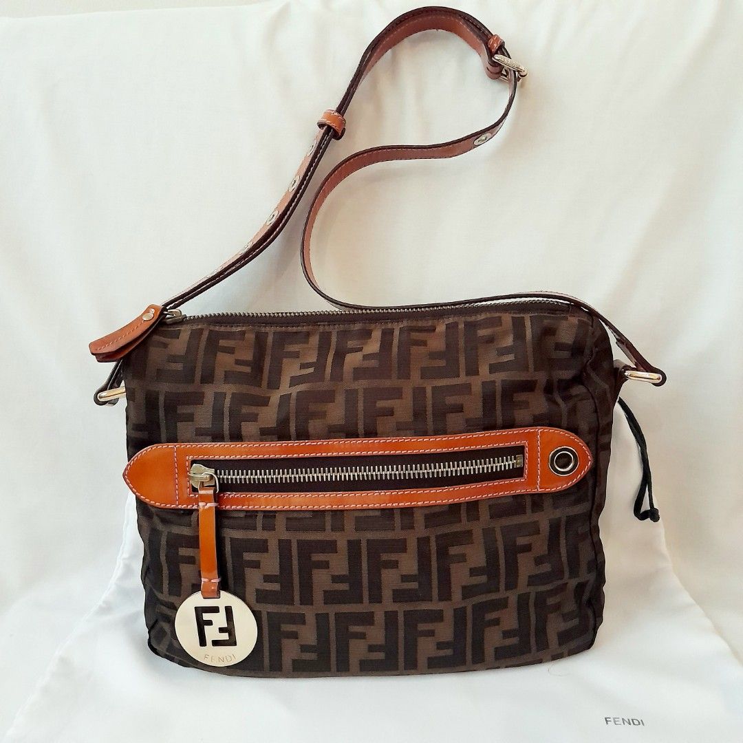 Fendi Zucca Crossbody Bag (Category: Luxury Bags & Wallets) located in Quezon City. Submitted by lovedlux (Listing ID 1389625482, Image 1). Description: Logos are back! Signature Fendi fabric including lining Two inside pockets H 22cm x W 26cm x D 8cm Adjustable strap With original dustbag Last pic for pre-owned price reference Selling cheap, minor stains on patent leather due to storage.