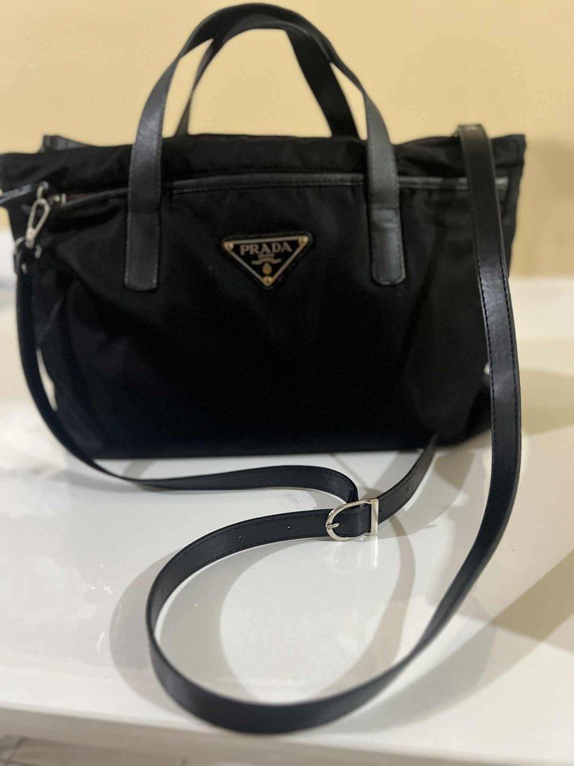 Authentic Prada 2 way bag (Category: Luxury Bags & Wallets) located in Quezon City. Submitted by jhaediah (Listing ID 1384555209, Image 1). Description: original preloved fits laptop with cert of authentication with generic strap 83.