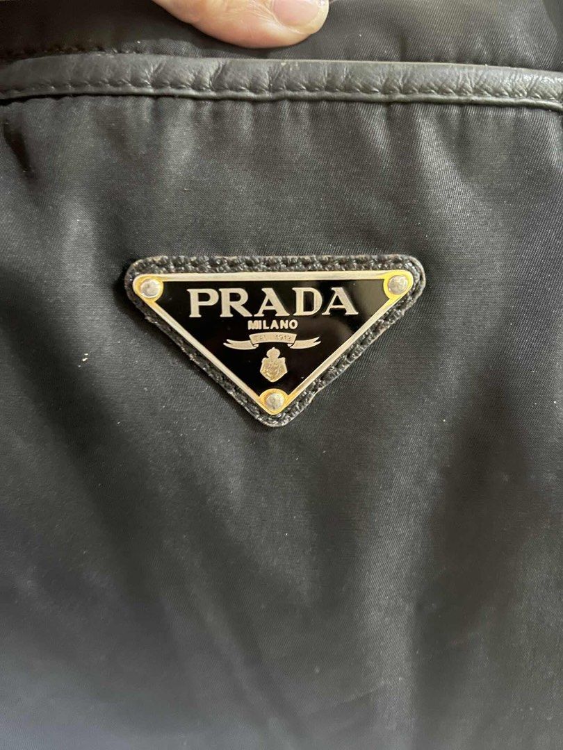 Authentic Prada 2 way bag (Category: Luxury Bags & Wallets) located in Quezon City. Submitted by jhaediah (Listing ID 1384555209, Image 2). Description: original preloved fits laptop with cert of authentication with generic strap 83.