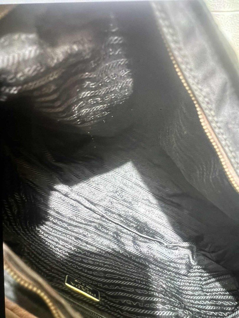 Authentic Prada 2 way bag (Category: Luxury Bags & Wallets) located in Quezon City. Submitted by jhaediah (Listing ID 1384555209, Image 3). Description: original preloved fits laptop with cert of authentication with generic strap 83.