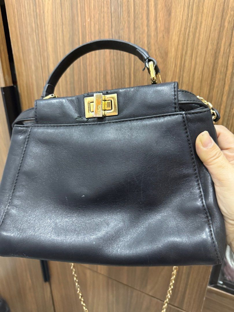 FENDI PEEKABOO SMALL (Category: Luxury Bags & Wallets) located in Manila. Submitted by madambags (Listing ID 1384451264, Image 1). Description: Fendi Peekaboo Condition : Well Used needs bag spa , sling is replaced Size : Small Color : Black Made : Leather For your self authentication 2nd owner .