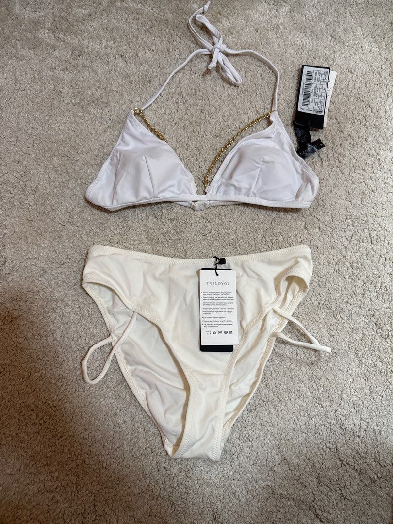 TRIANGL White Bikini Set with Gold Chain Detail (Category: Bikinis & Swimsuits) located in Singapore. Submitted by buyfromhereplz (Listing ID 1384567921, Image 1). Description: - Brand new TRIANGL bikini set - White triangle top with gold chain detailing - Matching bottoms included - Both pieces have original tags - Perfect for beach getaways!.